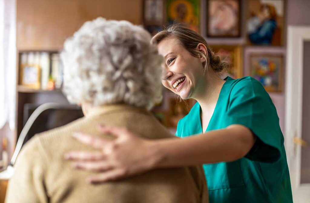 Older adult and family member reviewing care costs and documents at a kitchen table.